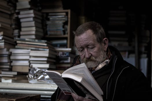 an old home inspector reading a book to become better educated